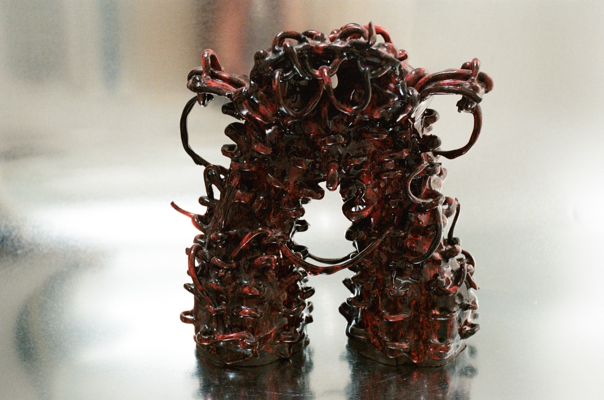 Red braided ceramic vessel, paired view